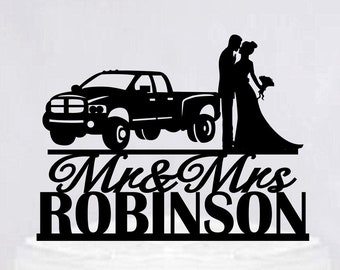 May include: Black silhouette cake topper featuring a pickup truck, a bride and groom, and the text "Mr. & Mrs. ROBINSON".