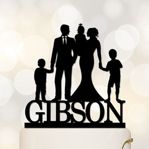 May include: Black silhouette of a family of five, including a bride and groom, holding hands. The family's last name, "GIBSON", is written in large, bold letters below the silhouettes.