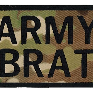 May include: A black patch with a camouflage background and the text "ARMY BRAT" in white.