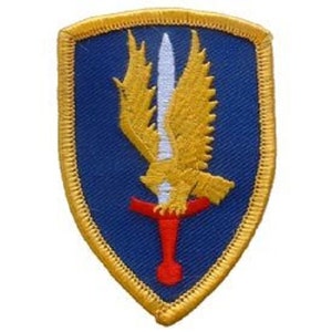 May include: A blue and gold embroidered patch with a golden eagle holding a red and white sword.