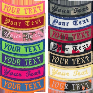 May include: A set of 10 embroidered patches with a curved shape. The patches are in various colors and patterns, including camouflage, pink, red, blue, green, purple, orange, and black. Each patch has the text "YOUR TEXT" embroidered in white.