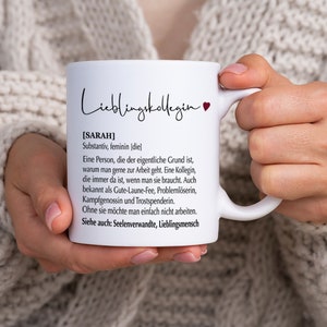 May include: White ceramic mug with a black and red design. The mug features the text "Lieblingskollegin" and a definition of the word "Sarah" in German.