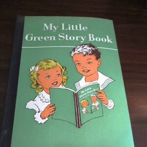May include: A green book with the title "My Little Green Story Book" on the cover. Two children are pictured on the cover, a girl with blonde hair and a boy with brown hair, both holding a book.