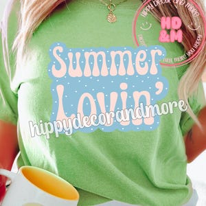 May include: A white ceramic mug with a black handle and the text "But First, Coffee" in a bold, black font. The mug is set against a blurred background, suggesting a cozy setting.