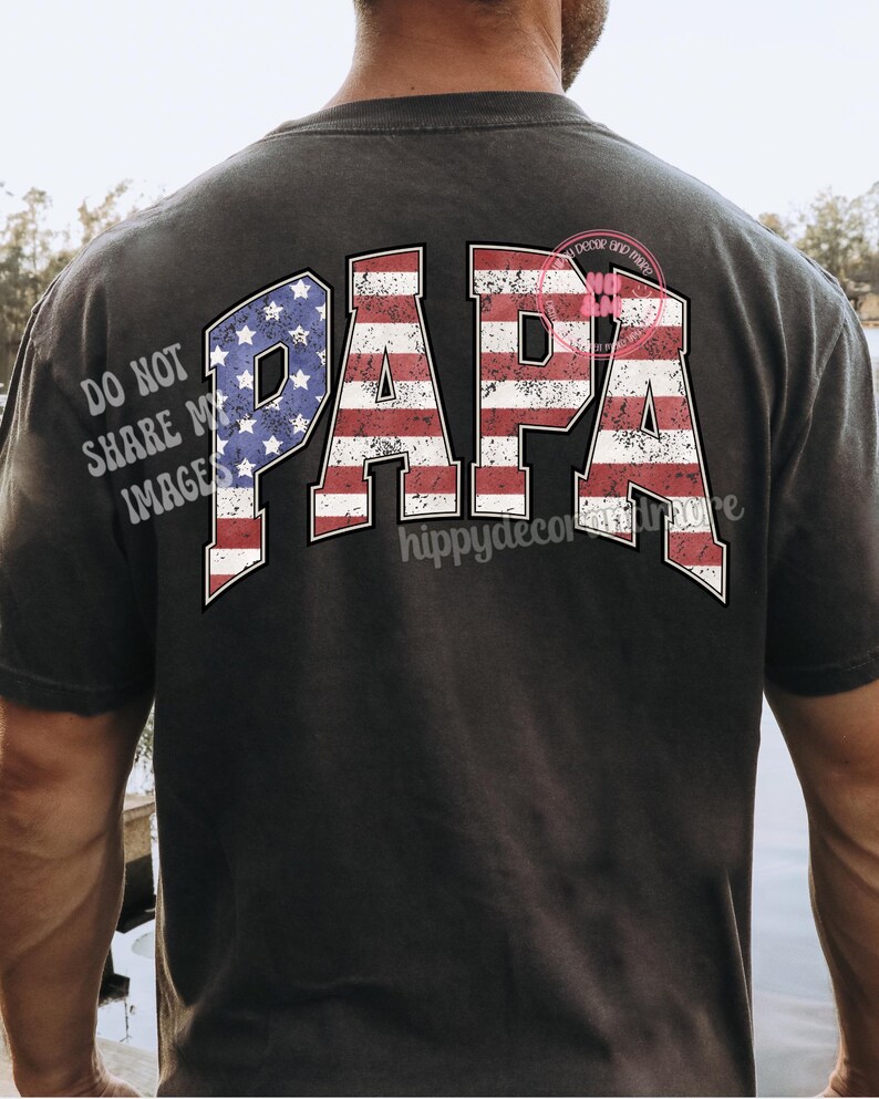 Puede incluir: Una camiseta negra con la palabra "PAPA" impresa en la espalda en letras blancas. Las letras est&aacute;n delineadas en rojo y azul, asemej&aacute;ndose a la bandera espa&ntilde;ola.