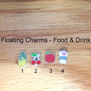 May include: Four silver charms with different food and drink designs.  The charms are numbered 1 through 4.  Charm 1 is a pineapple, charm 2 is a cherry, charm 3 is an apple, and charm 4 is a cup of coffee.