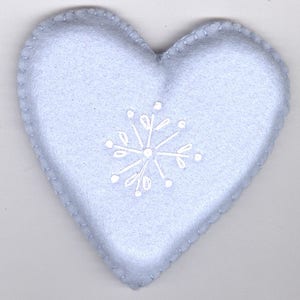 May include: A light blue felt heart-shaped ornament with a white snowflake design.