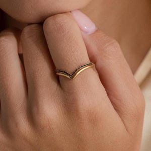 May include: A set of three ceramic mugs with a speckled, matte finish. The mugs are in shades of cream, light gray, and dark gray. Each mug has a simple, modern design and a rounded handle.