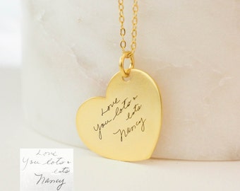 May include: Gold heart-shaped necklace with a handwritten message that reads "Love you lots & lots Nancy".