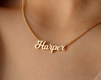 May include: A gold necklace with the name "Harper" spelled out in cursive script.