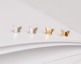 May include: Three pairs of butterfly earrings in silver, gold, and rose gold. The earrings are small and delicate, and they are perfect for everyday wear.