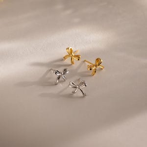 Schleifenohrstecker von Caitlyn Minimalist • Zarte Ohrringe mit Schleifenanhänger • Niedliche Mini-Ohrringe • Goldschmuck • Geschenk für die Tochter • ER682