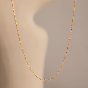 Close-up of the Dot Station Necklace in gold, featuring a dainty beaded chain design.