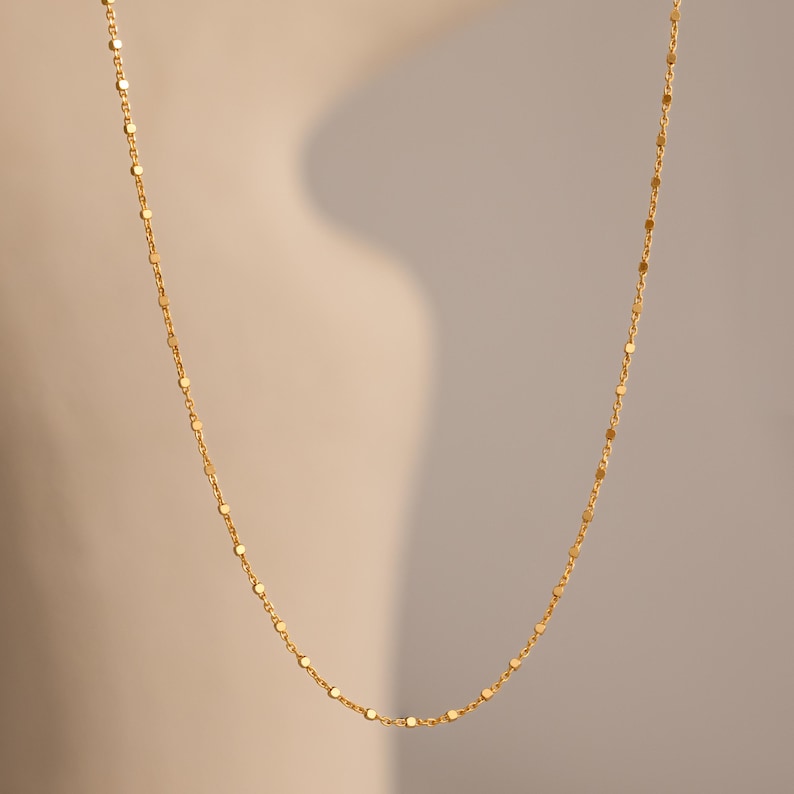 Close-up of the Dot Station Necklace in gold, featuring a dainty beaded chain design.