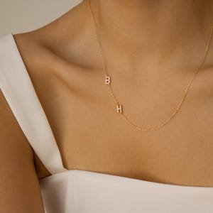 May include: A set of three ceramic mugs with a speckled, matte finish. The mugs are in shades of cream, light gray, and dark gray. Each mug has a simple, modern design and a rounded handle. Perfect for coffee or tea.