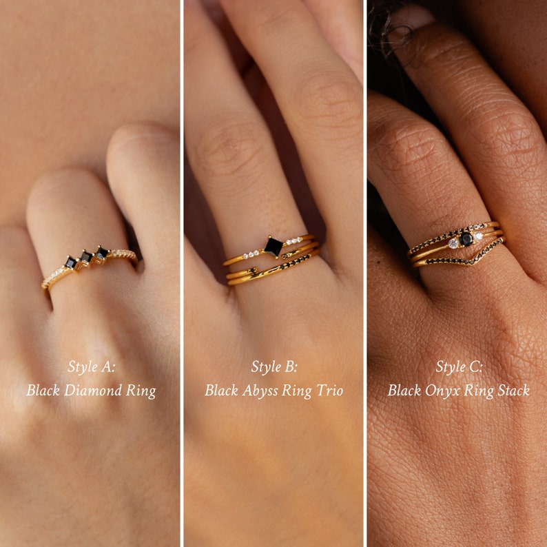 May include: Three gold rings with black gemstones and white diamonds. The first ring has three black square gemstones. The second ring has a black square gemstone and a thin band with white diamonds. The third ring has a black round gemstone and a V-shaped band with white diamonds.
