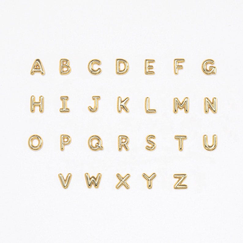 Gold bubble initial stud earrings arranged in a full A to Z alphabet set, displayed in neat rows on a clean white background, highlighting the polished rounded letter design and available options.