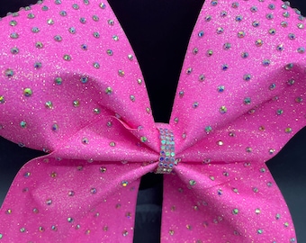 May include: A large pink cheer bow with iridescent glitter and rhinestones.