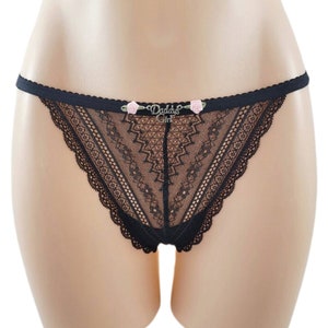 May include: Black lace underwear with a delicate floral design and the text "Daddy's Girl" on the front.