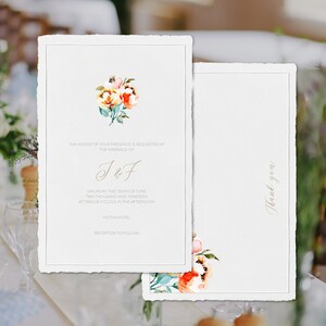 May include: Elegant wedding invitation with watercolor floral accents in peach, yellow, and green. The invitation includes the text "The honor of your presence is requested at the marriage of J&F" and "Thank you" on the back.