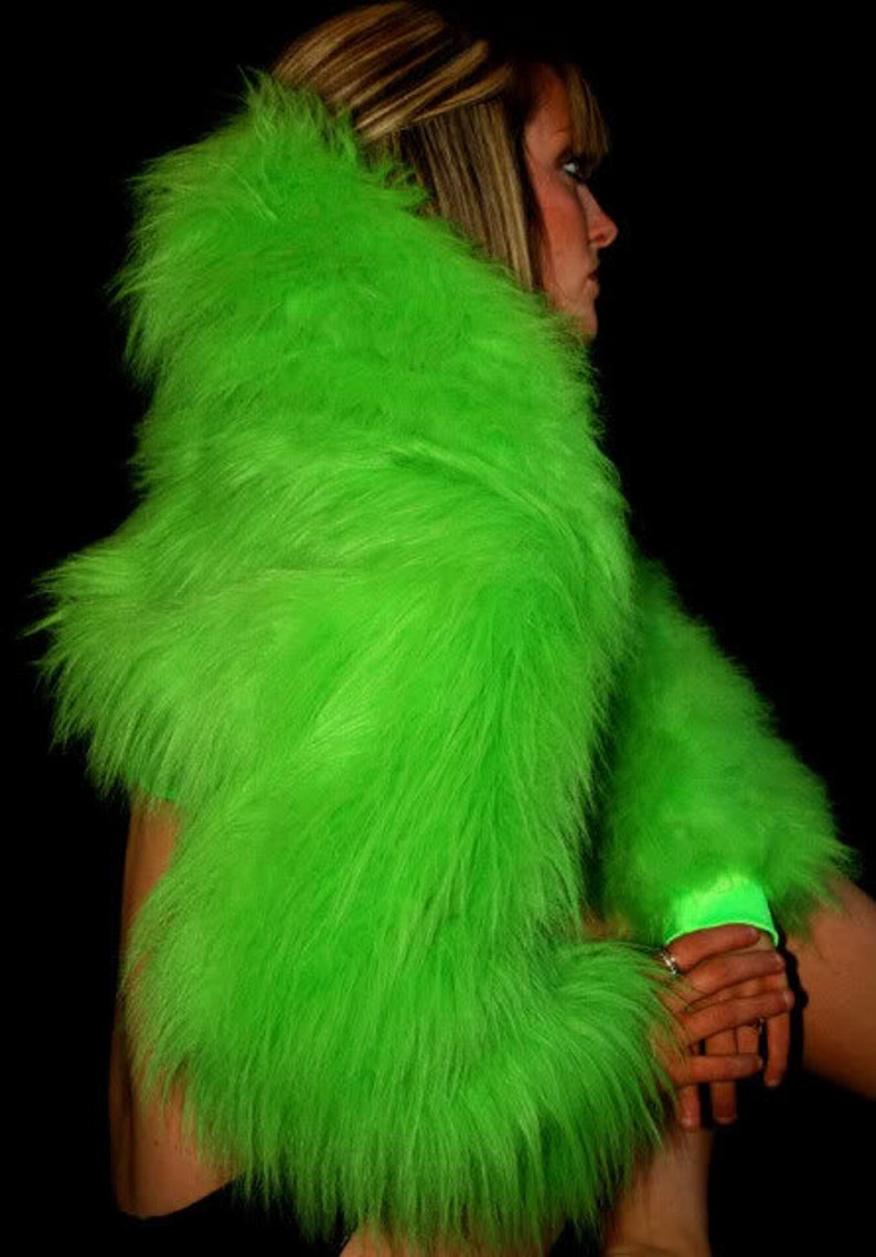 May include: A bright green faux fur shrug with long sleeves. The fur is very fluffy and soft.
