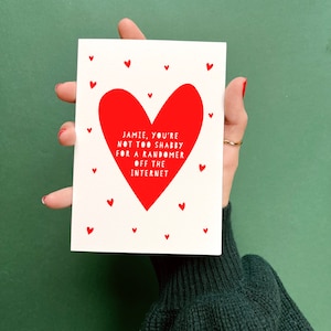 May include: A white card with a red heart and the text "Jamie, you're not too shabby for a randomer off the internet".