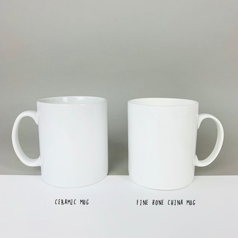 May include: Side-by-side comparison of two white mugs. The mug on the left is labeled "Ceramic Mug". The mug on the right is labeled "Fine Bone China Mug".