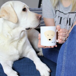 May include: White ceramic mug with a cartoon illustration of a yellow Labrador Retriever and the text "Love you, paw".
