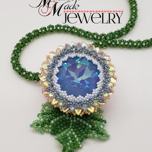 May include: A beaded necklace with a large blue iridescent crystal surrounded by white, gold, and pink beads. The pendant is attached to a green beaded chain. The necklace is labeled "Madison Made Jewelry".