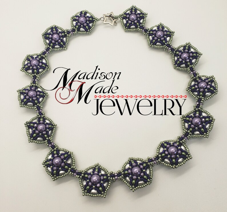 May include: A silver and purple beaded necklace with a star charm. The necklace is made of small, round beads and features a repeating pattern of star-shaped motifs. The necklace is approximately 18 inches long.