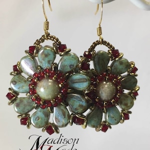 May include: A pair of gold earrings with a floral design. The flowers are made of turquoise and white beads with red accents. The earrings are hanging from gold hooks.