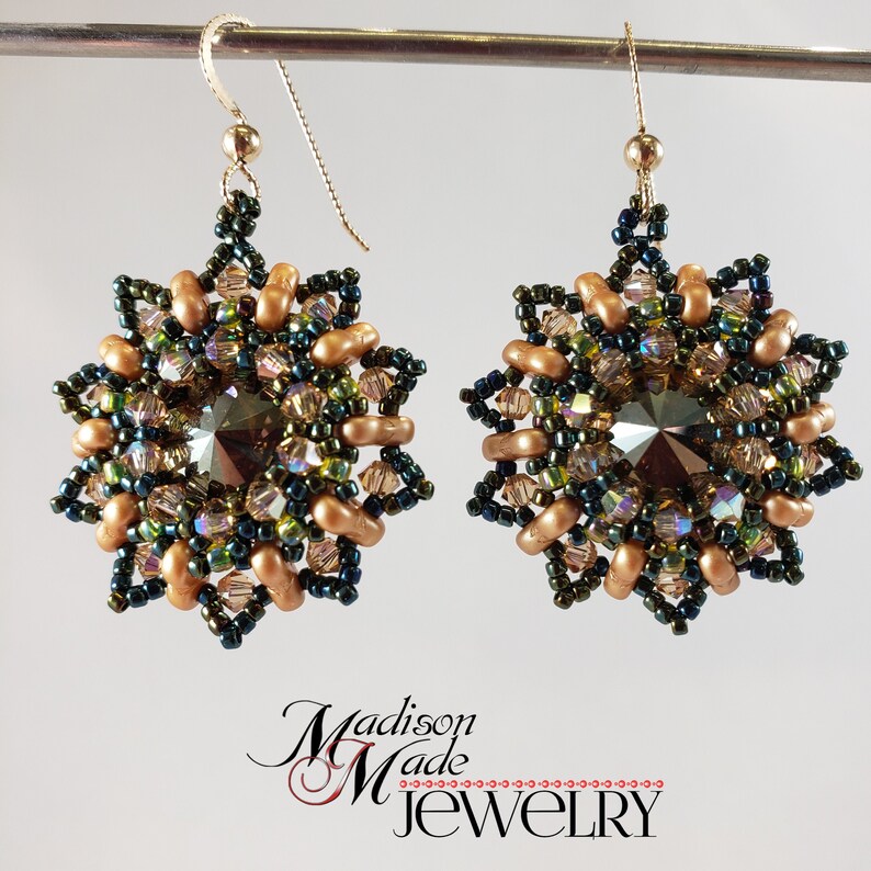 May include: A pair of gold and green beaded earrings with a crystal centre. The earrings are in the shape of a starburst.