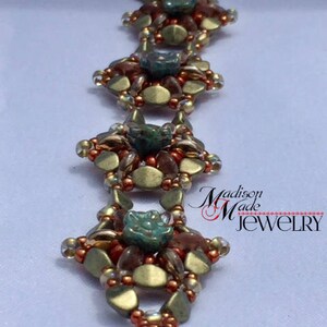 May include: A gold, brown, and green beaded bracelet with a flower design. The bracelet is made with small, round beads and has a delicate, intricate design. The bracelet is accented with a small, turquoise-colored bead in the center of each flower.