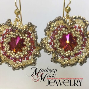 May include: A pair of gold earrings with a pink and gold beaded design. The earrings feature a round, iridescent pink crystal in the center of each earring.