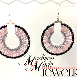 May include: A pair of hoop earrings with a layered design of pink, purple, and black beads. The earrings are made with silver hooks.
