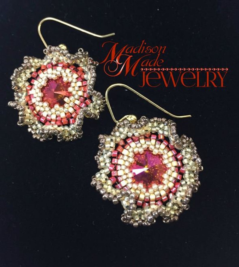 May include: A pair of gold earrings with a red, white, and gold beaded flower design. The earrings feature a red crystal in the center of each flower.