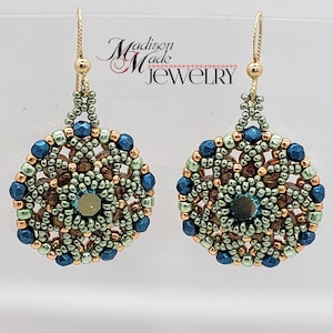 May include: A pair of gold beaded earrings with a teal, green, and copper colour scheme. The earrings feature a circular design with a central teal bead.