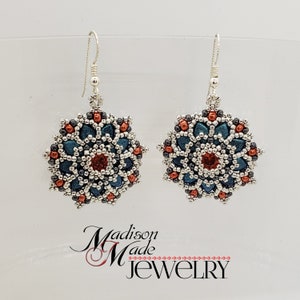May include: A pair of handmade beaded earrings. Each earring features a floral design with teal, red, and silver beads. The earrings are suspended from silver-colored ear wires. The text "Madison Made Jewelry" is visible.