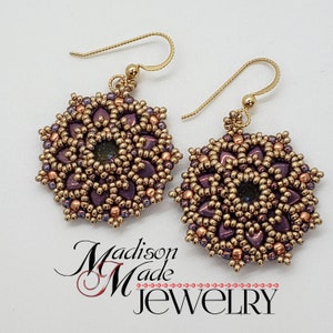 May include: A pair of handmade beaded earrings with a floral design. The earrings feature a central dark stone surrounded by purple and gold beads. The ear wires are gold-colored. The text "Madison Made Jewelry" is visible.