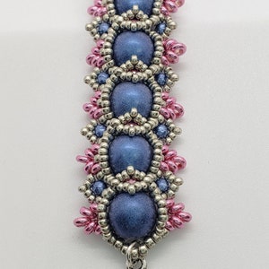 May include: A blue beaded bracelet with silver and pink beads. The bracelet has a heart charm and the text "Madison Made Jewelry" and "Blue" on the bottom.