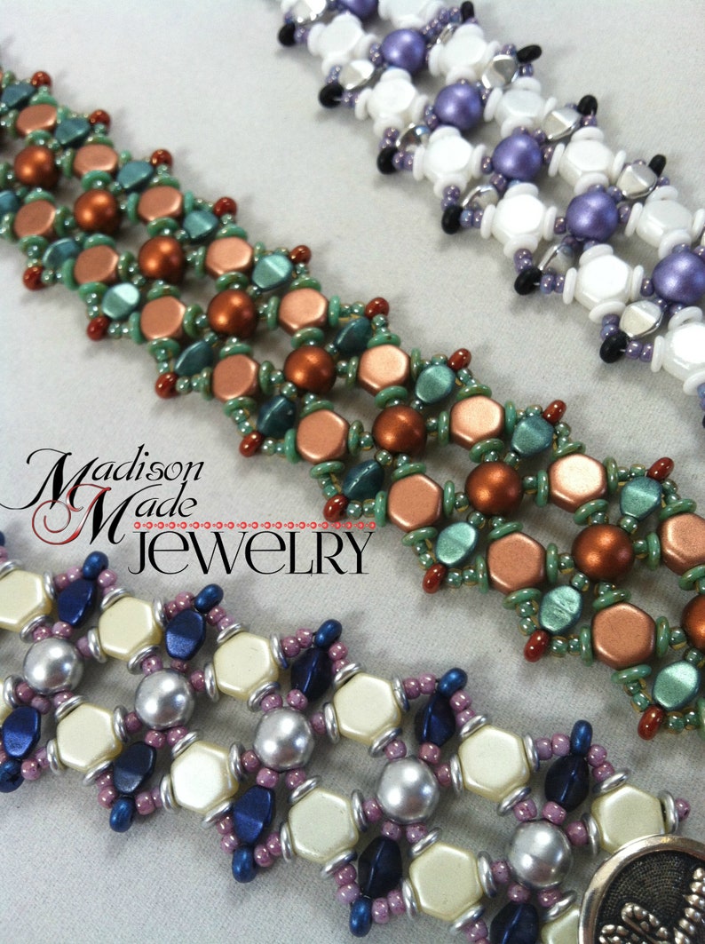 Op de afbeelding: Drie kralenarmbanden met verschillende kleurcombinaties. De bovenste armband heeft witte, paarse en zilveren kralen. De middelste armband heeft koperen, groene en rode kralen. De onderste armband heeft cr&egrave;mekleurige, zilveren, blauwe en paarse kralen. Alle armbanden zijn gemaakt met kleine, ronde kralen en hebben een geometrisch patroon.