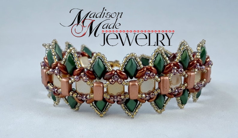 May include: A beaded bracelet with a repeating pattern of green diamond-shaped beads, copper-colored rectangular beads, and cream-colored square beads. The bracelet is labeled "Madison Made Jewelry" in a cursive font.