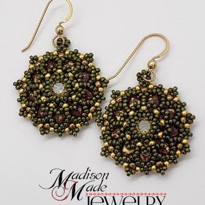 May include: A pair of handmade beaded earrings. The earrings feature a circular design with olive green, gold, and burgundy beads. Each earring has a gold-colored hook and a small, iridescent bead in the center. The earrings are displayed on a white background.