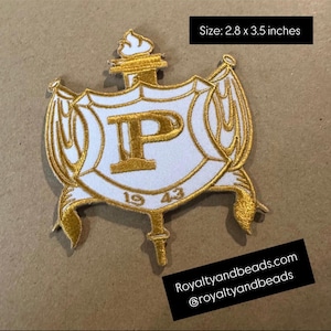 May include: Embroidered patch featuring a white shield with a gold border and accents. The shield displays a gold "P" and the year "1943". The patch measures 2.8 x 3.5 inches and includes the text "Royaltyandbeads.com".