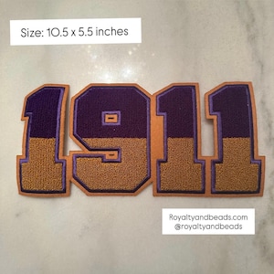 May include: A large patch with the number "1911" in purple and gold. The patch measures 10.5 x 5.5 inches. The text "Royaltyandbeads.com @royaltyandbeads" is at the bottom.