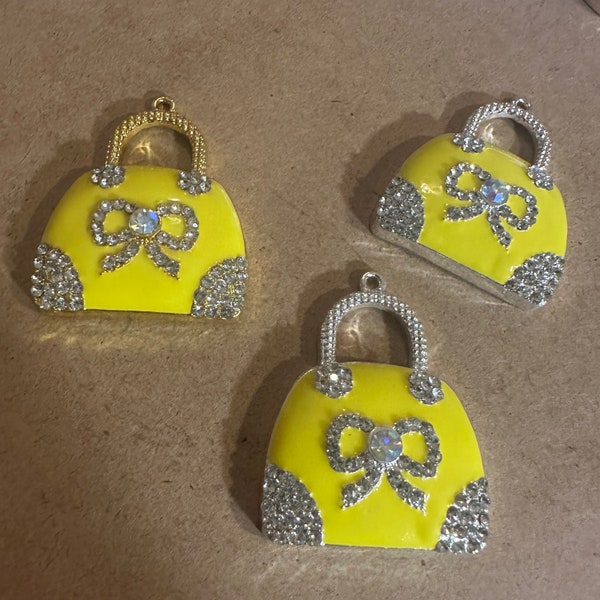 3 yellow purse charms