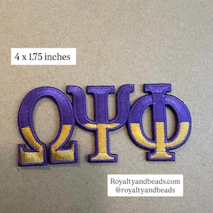 May include: Embroidered patch featuring the Greek letters Omega, Psi, and Phi in purple and gold. The patch measures 4 x 1.75 inches. The text "Royaltyandbeads.com @royaltyandbeads" is also visible.