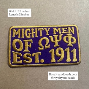 May include: A rectangular embroidered patch with a purple background and gold border. It features the gold text MIGHTY MEN OF ΩΨΦ EST. 1911. The patch measures 3.3 inches in width and 2 inches in length. The text Royaltyandbeads.com is also visible.