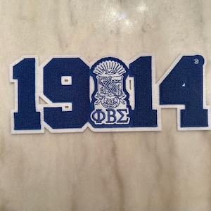 May include: Blue and white felt patch with the year 1914 and the Greek letters Phi Beta Sigma.