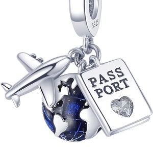 May include: Silver charm featuring a globe with blue enamel, a small airplane, and a passport charm with a crystal heart. The charm is marked with "S925" for sterling silver.